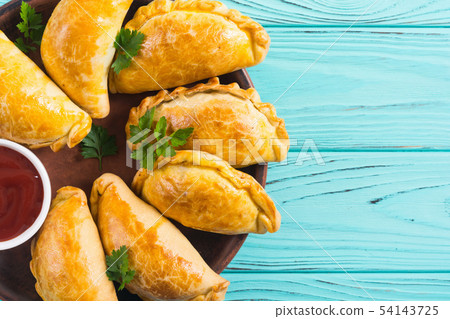 Latin American baked beef empanadas with sauce Latin American baked beef empanadas with sauce 54143725