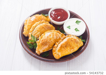 Latin American baked beef empanadas with sauce Latin American baked beef empanadas with sauce 54143732