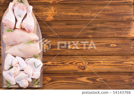 Raw chicken meat on wooden background Raw chicken meat on wooden background 54143766