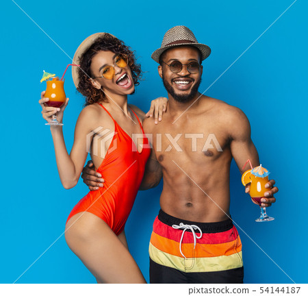 Friendly african american couple enjoying fresh drinks Friendly african american couple enjoying fresh drinks 54144187
