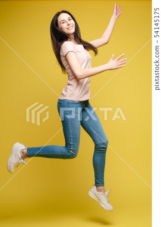 Cheerful brunette young woman in casual outlook Cheerful brunette young woman in casual outlook 54145175