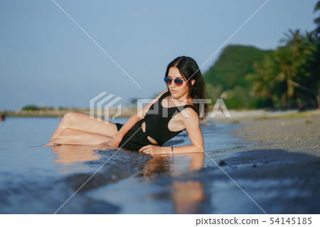 Girl laying on the beach Girl laying on the beach 54145185