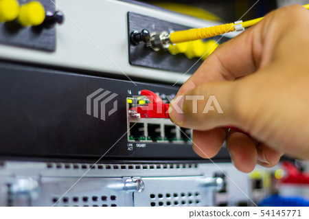 Hand of man holding The network cables to connect Hand of man holding The network cables to connect 54145771