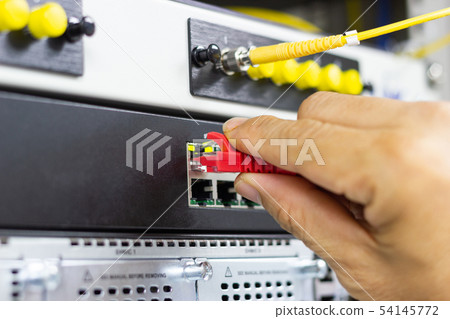Hand of man holding The network cables to connect Hand of man holding The network cables to connect 54145772