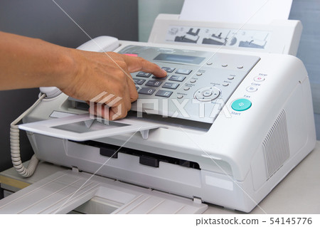 hand man are using a fax machine in the office hand man are using a fax machine in the office 54145776