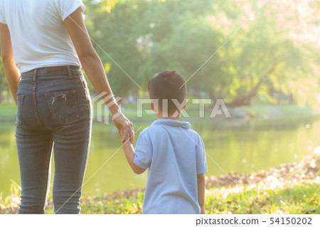 Asian mother or parent and son holding hand 54150202