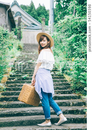 A woman climbing the stairs 54150398