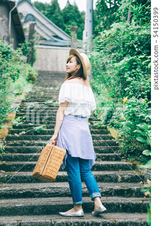 A woman climbing the stairs A woman climbing the stairs 54150399