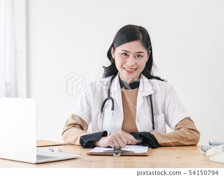 Female Asian doctor working at office desk and Female Asian doctor working at office desk and 54150794
