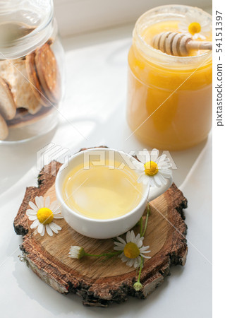 Cup of herbal tea, honey and chamomile on the Cup of herbal tea, honey and chamomile on the 54151397