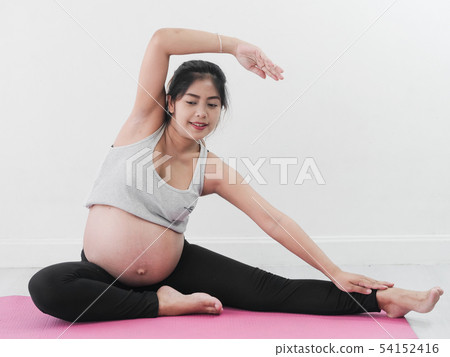 Asian pregnant woman doing yoga at home, lifestyle Asian pregnant woman doing yoga at home, lifestyle 54152416