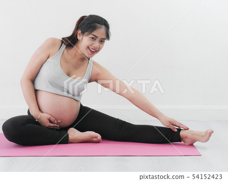 Asian pregnant woman doing yoga at home, lifestyle Asian pregnant woman doing yoga at home, lifestyle 54152423