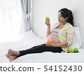 Asian pregnant woman drinking orange juice and 54152430