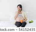 Asian pregnant woman drinking orange juice and 54152435