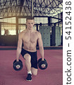 Handsome mandoing the exercises with dumbbells. 54152438