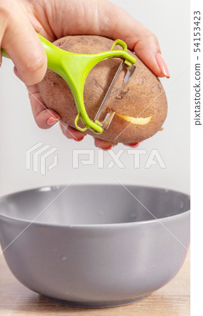 woman cook cleans potatoes woman cook cleans potatoes 54153423