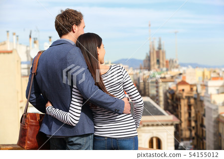 Romantic couple looking at view of Barcelona Romantic couple looking at view of Barcelona 54155012