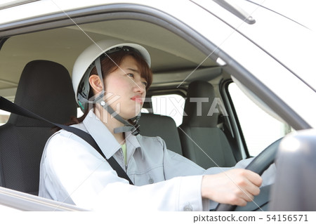 Young woman wearing a workwear addicted to traffic Young woman wearing a workwear addicted to traffic 54156571
