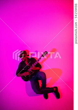 Young african-american jazz musician playing the guitar Young african-american jazz musician playing the guitar 54159498