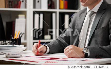 Businessman working and calculating, reads and 54160397