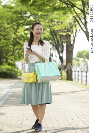 A woman watching a smartphone 54161903