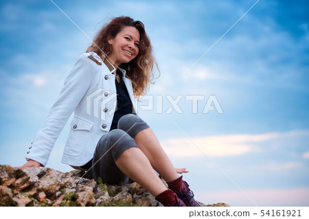 fashionable girl dressed in white jacket and wide 54161921