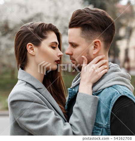 Beautiful young couple embraces on the street 54162708
