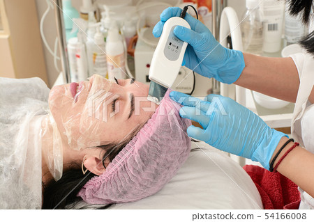 Young woman in beauty salon doing peeling and 54166008