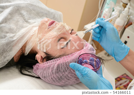 Young woman in beauty salon doing peeling and Young woman in beauty salon doing peeling and 54166011