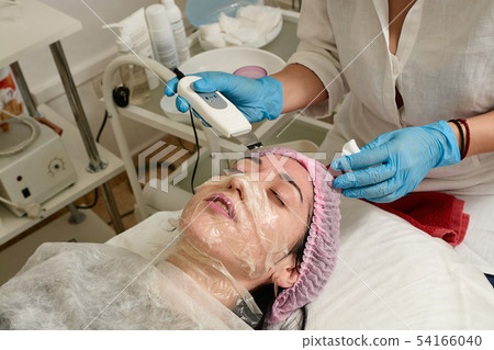 Young woman in beauty salon doing ultrasound Young woman in beauty salon doing ultrasound 54166040