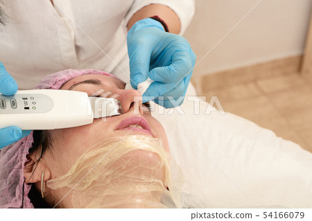 Young woman in beauty salon doing ultrasound Young woman in beauty salon doing ultrasound 54166079