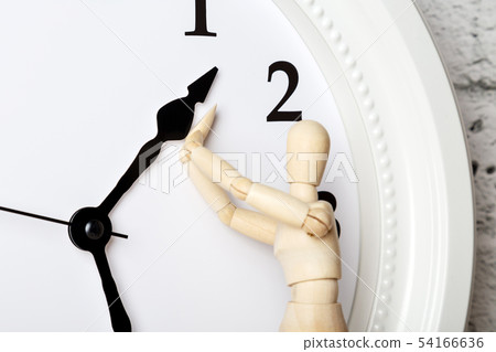 Wooden human figure trying to stop the arrow of 54166636