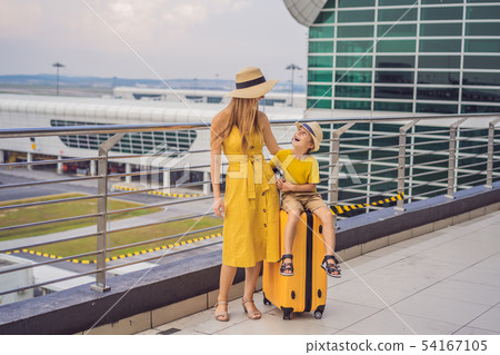 Family at airport before flight. Mother and son waiting to board at departure gate of modern Family at airport before flight. Mother and son waiting to board at departure gate of modern 54167105