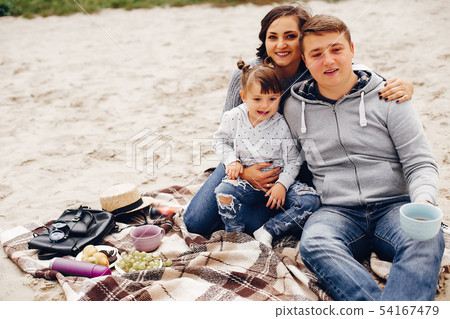 Fathet with daughter playing on a sand Fathet with daughter playing on a sand 54167479