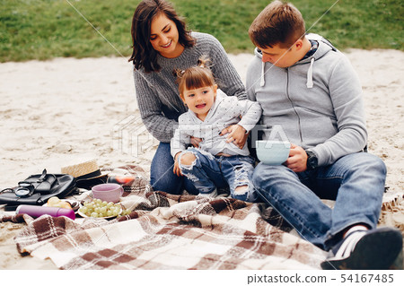Fathet with daughter playing on a sand Fathet with daughter playing on a sand 54167485