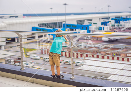 Family at airport before flight. Boy waiting to board at departure gate of modern international 54167496