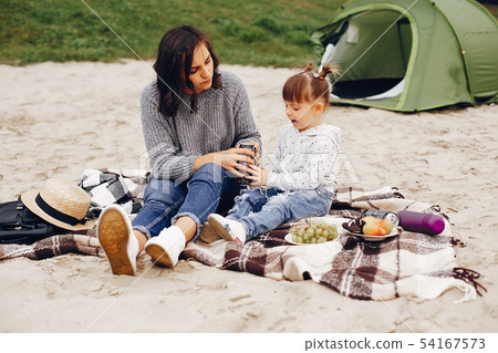 Mother with daughter playing in a summer park Mother with daughter playing in a summer park 54167573