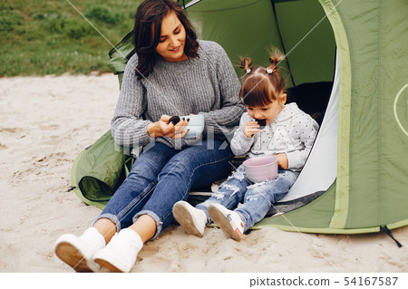 Mother with daughter playing in a summer park Mother with daughter playing in a summer park 54167587