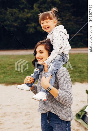 Mother with daughter playing in a summer park Mother with daughter playing in a summer park 54167752