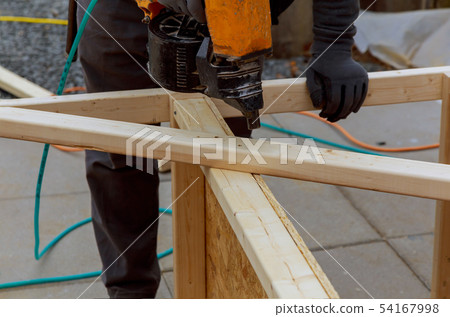 Worker installing wood floor for hammering Worker installing wood floor for hammering 54167998