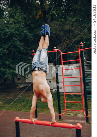 Handsome man training in a summer park 54168632