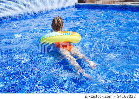 Pretty little girl with african blue pigtails swimming with circle in outdoor pool and have a fun Pretty little girl with african blue pigtails swimming with circle in outdoor pool and have a fun 54168828
