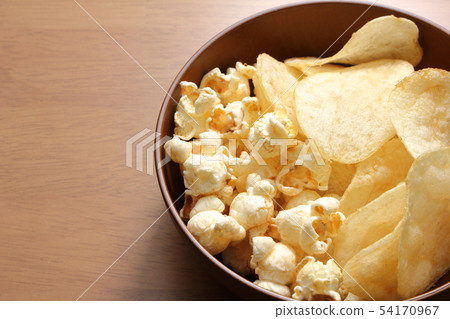 Potato chips and popcorn. Assorted two kinds of snacks. Potato chips and popcorn. Assorted two kinds of snacks. 54170967
