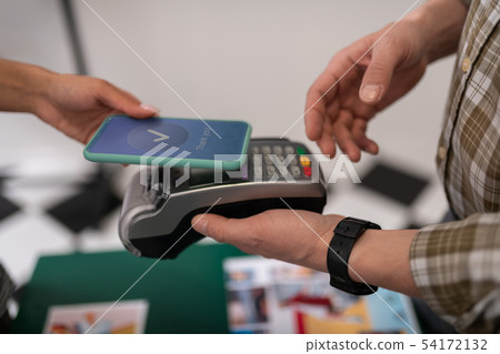 Close-up of a customer doing a successful payment via PayPass 54172132