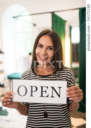 Face-portrait of store owner keeping an open sign in hands Face-portrait of store owner keeping an open sign in hands 54172190