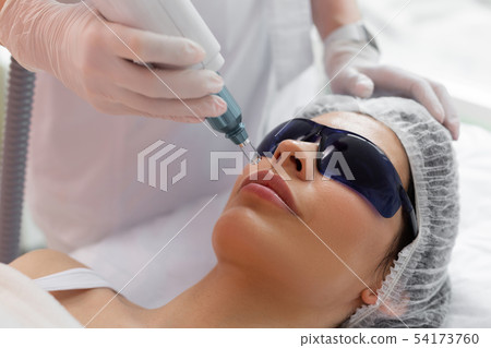Nice pretty woman having a laser facial epilation Nice pretty woman having a laser facial epilation 54173760
