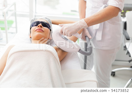 Nice pleasant woman having her underarm depilated 54173852