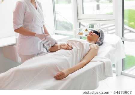 Pleasant nice woman having her hair removed 54173907