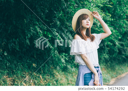 A woman walking along a country road 54174292