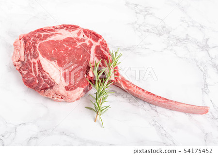 tomahawk ribeye steak on marble background tomahawk ribeye steak on marble background 54175452